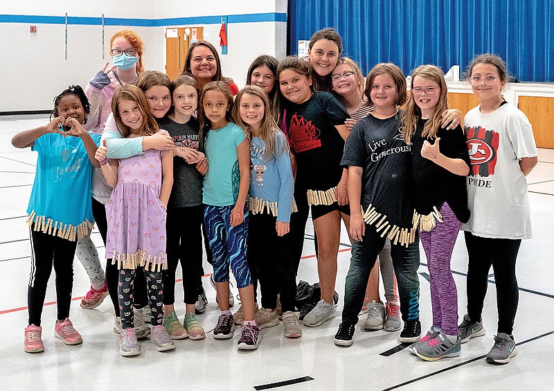 The Girls on the Run fitness program poses for a group photo on Wednesday, Oct. 27, 2021, at North Elementary School gymnasium in Holts Summit, Mo. (Ethan Weston/News Tribune photo)