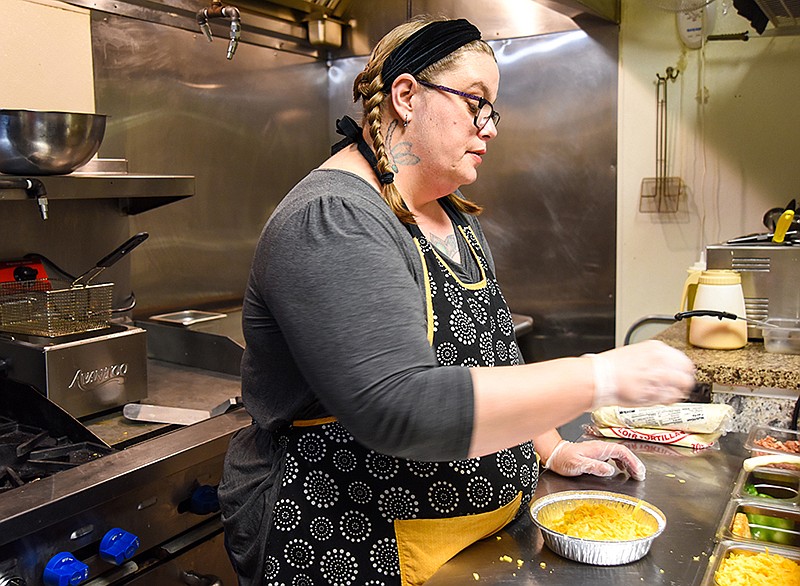 Amanda Jensen works in her kitchen at La Chica Loca, at 306 E. High St. in Jefferson City, where she was busy making bowls and burritos Thursday, Oct. 28, 2021, as online orders came in. (Julie Smith/News Tribune photo)