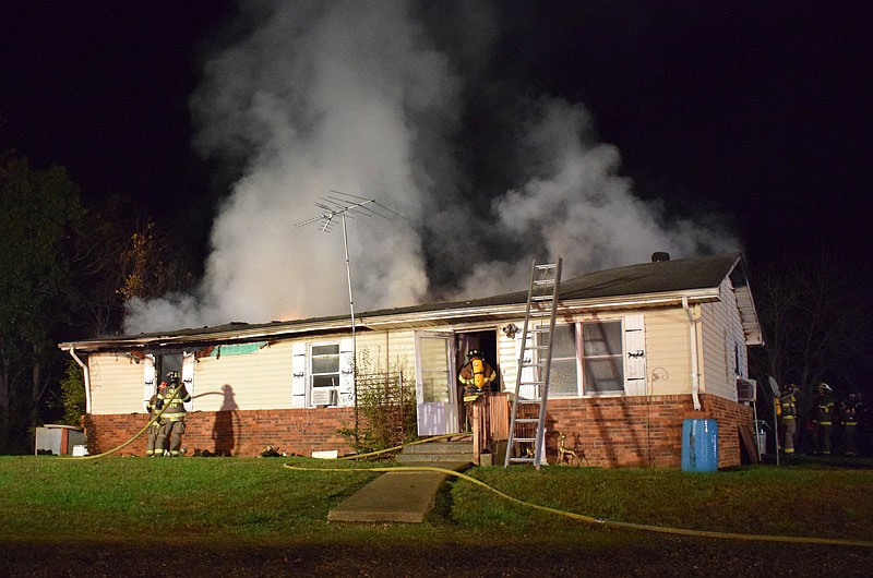 This photo provided by the Cole County Fire Protection District shows firefighters at a house fire Sunday night, Oct. 31, 2021, in the 6000 block of Loesch Road.