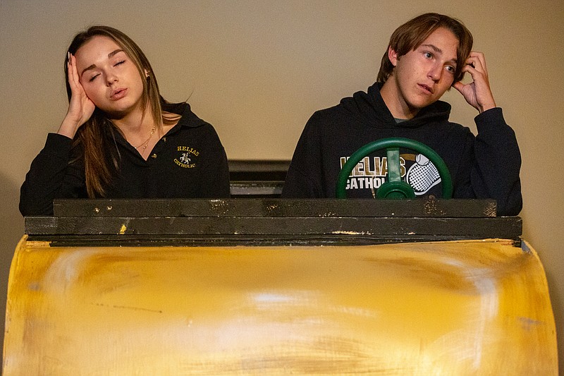Ethan Weston/News Tribune Lainey Hood and Jonah Lanigan sit in a prop car during rehearsal for Short Attention Span Theater on Tuesday, November 2, 2021 at Scene One Theater in Jefferson City, Mo. The show will feature multiple short plays, each featuring the prop car.