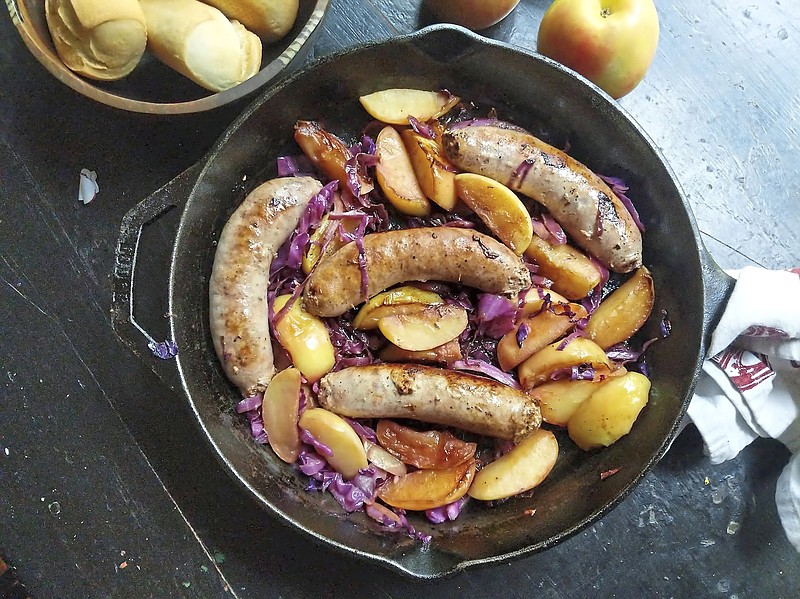 Sweet Italian sausage sizzles in the same pan as sliced apple and red cabbage in this easy skillet recipe. (Gretchen McKay/Pittsburgh Post-Gazette/TNS)