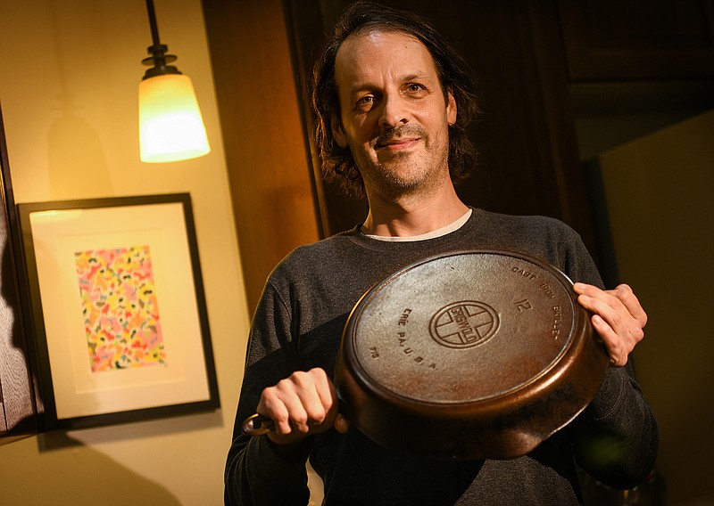 Mike Sanders, a concert promoter and club owner, with one of his restored Griswold cast iron skillets at Sanders’s Lawrenceville home on Monday, Oct. 25, 2021. (Steve Mellon/Pittsburgh Post-Gazette/TNS)