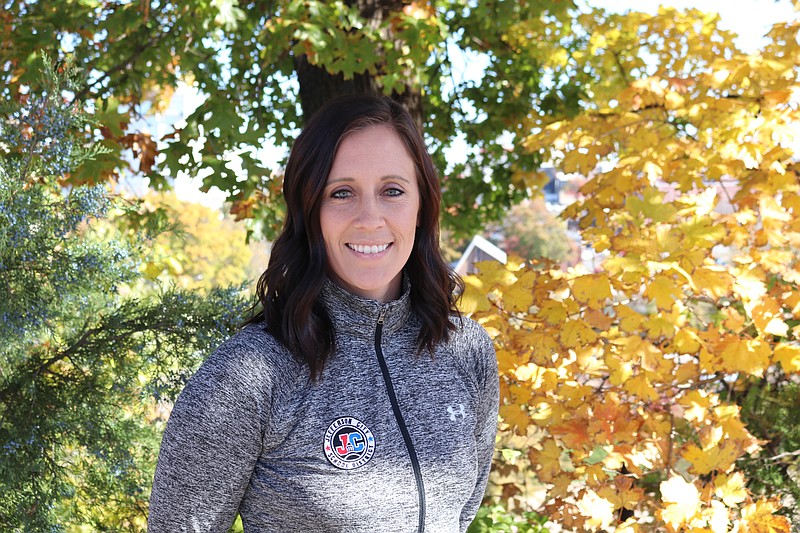 <p>Anna Campbell/News Tribune</p><p>JC Healthy Schools coordinator Kelsey Chrisman stands in front of fall foliage outside her office.</p>