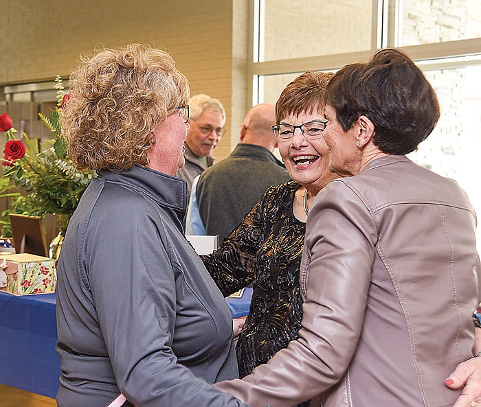 Rosie Verslues, middle, is congratulated by Renee Gargus, left, and her sister Debbie Mullaly, on her retirement after 50 years at Home Savings Bank, now Legends Bank. Gargus and Mullaly's father, Harold Asher, hired Verslues in 1971, when Debbie was very young and before Renee was even born. Verslues has seen the girls grow up and they consider Verslues a very close family friend.