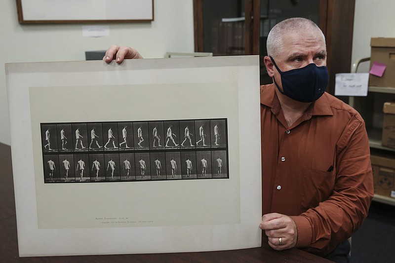 J.J. Ahern, a senior archivist at the University of Pennsylvania, displays stop-motion images of a neurological patient named H.V. Rogers, taken in 1885. (Steven M. Falk/The Philadelphia Inquirer/TNS)