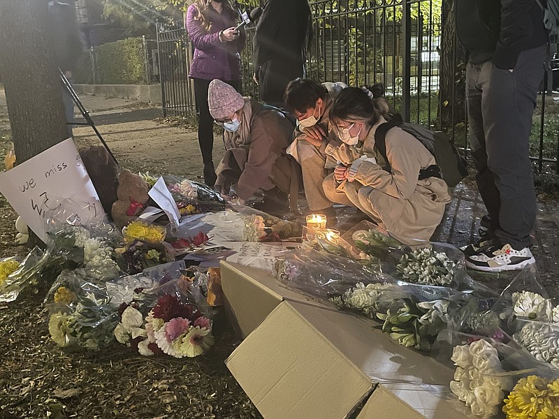 Students and friends of Shaoxiong "Dennis" Zheng  stop by a memorial on Wednesday, Nov. 10, 2021 in Chicago.  Police say Zheng was fatally shot while on the sidewalk shortly before 2 p.m. Tuesday.  The slaying of the Chinese college student fatally shot during an armed robbery near the University of Chicago campus prompted the school's president to call for city officials to treat violence as a “public health crisis.” (Madeline Kenney/Chicago Sun-Times via AP)