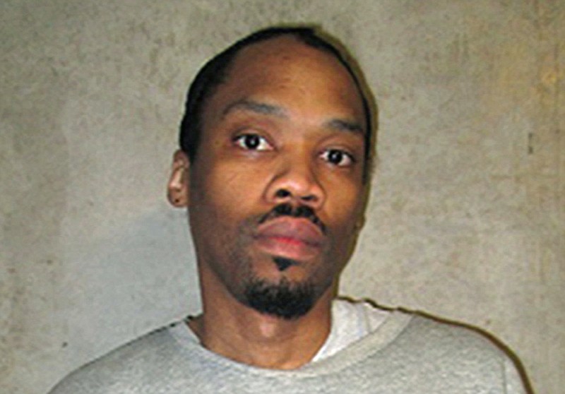 FILE - This photo provided by the Oklahoma Department of Corrections shows Julius Jones  Feb. 5, 2018, file. Oklahoma Gov. Kevin Stitt has agreed to commute the death sentence of condemned inmate Julius Jones, who was convicted of murder for a 1999 killing. Stitt announced his decision on Thursday, Nov. 18, 2021, the day of Jones’ scheduled execution. (Oklahoma Department of Corrections via AP, File)