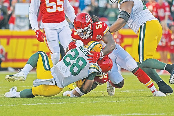 Chiefs outside linebacker Nick Bolton (54) and free safety Tyrann Mathieu tackle Packers running back A.J. Dillon during a game earlier this month at Arrowhead Stadium.