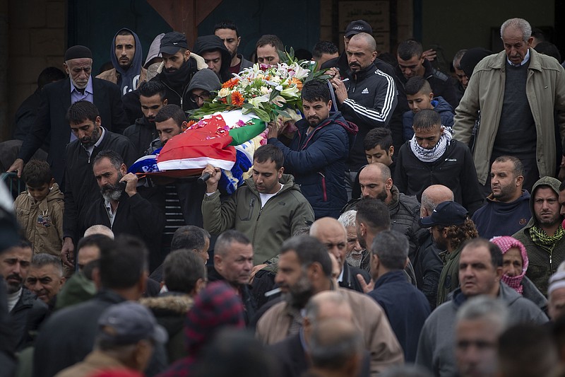 Palestinians carry the body of Isra Khazimia who was killed by Israeli fire after allegedly trying to stab an officer in Jerusalem's Old in September, during her funeral in the West Bank village of Qabatiya, Saturday, Nov. 20, 2021. Israel had withheld the body of Khazimia through its controversial policy of holding the remains of Palestinians killed while reportedly carrying out attacks, although agreed to return her to her family on "humanitarian grounds." At the time of her alleged attacks, Khazimia was reported to have had mental health issues.(AP Photo/Majdi Mohammed)