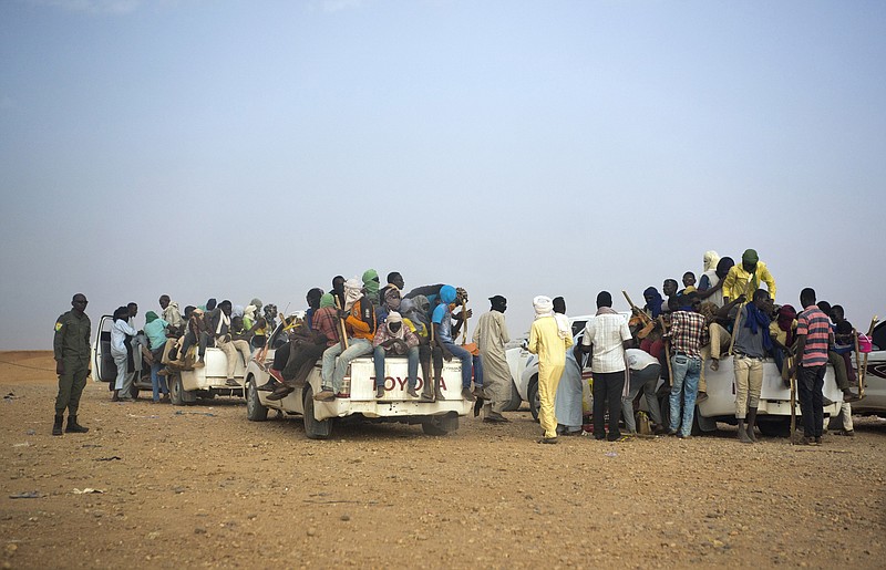 FILE - This June 14, 2018, file photo shows Nigeriens and third-country migrants head towards Libya from Agadez, Niger. The more than 66,000 United Nations peacekeepers are confronting greater threats today because conflicts have become more complex and are driven by an increasing number of factors ranging from ethnic tensions and the impact of organized crime to illegal exploitation of resources and terrorism, the U.N. peacekeeping chief said Friday, Nov. 19, 2021. (AP Photo/Jerome Delay, File)