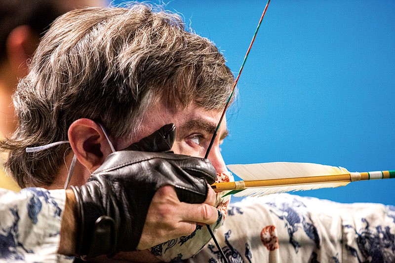 PJ McMurray draws back on a bow and arrow during an archery competition at the Society for Creative Anachronism's annual Toys for Tots toy drive on Saturday, Nov. 20, 2021, at The Zone in Jefferson City, Mo. McMurray has been a part of SCA on and off for about 15 years. (Ethan Weston/News Tribune photo)