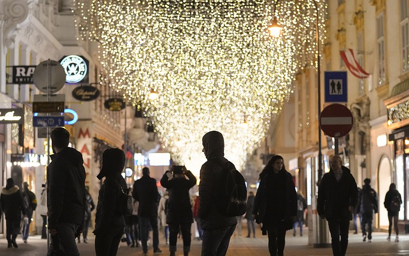 <p>AP</p><p>People walk Saturday on a street decorated with Christmas lights in Vienna, Austria. The Austrian government announced a nationwide lockdown that will start today and comes as average daily deaths have tripled in recent weeks and hospitals in heavily hit states have warned intensive care units are reaching capacity.</p>