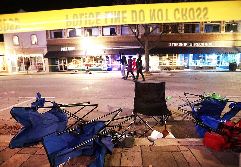 Toppled chairs line W. Main St. in downtown Waukesha, Wis., after an SUV drove into a parade of Christmas marchers Sunday, Nov. 21, 2021. (John Hart/Wisconsin State Journal via AP)