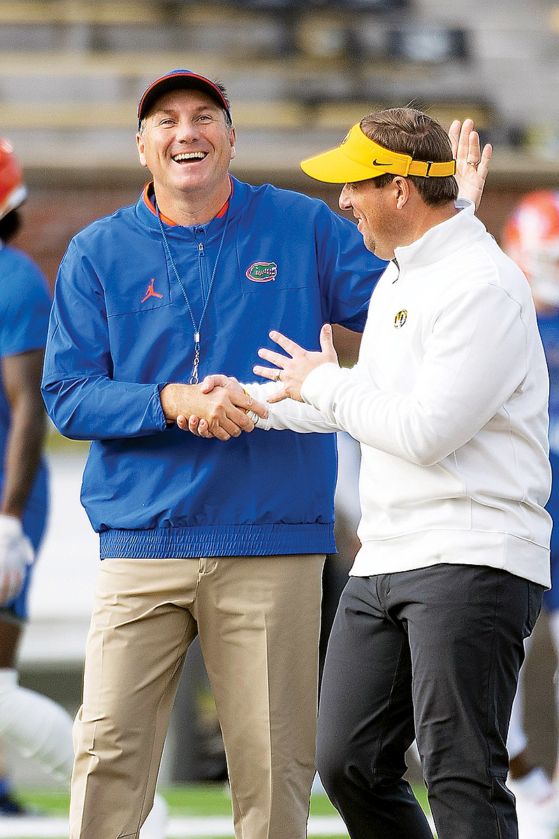 Florida coach Dan Mullen greets Missouri coach Eli Drinkwitz before Saturday's game at Faurot Field.