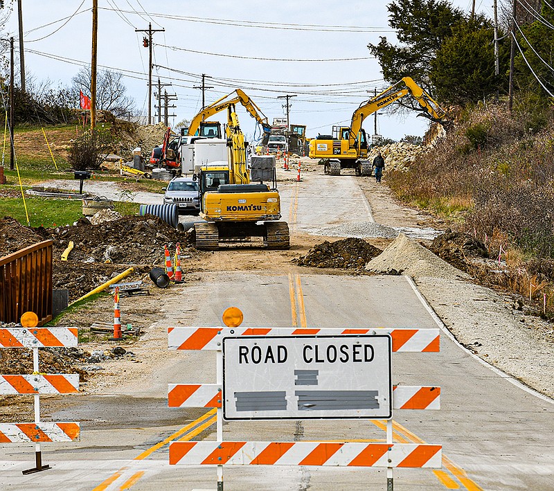 <p>Julie Smith/News Tribune</p><p>Don Schneiders Excavating chips away at the bluff on Business 50 between Apache Flats and St. Martins. Progress is being made as work continues on the project, which includes new curbs and guttering to both sides of the roadway, new pavement and a new intersection at Henwick Lane. Additionally, a new sidewalk will connect St. Martins with Apache Flats, with hopes to eventually connect it with Jefferson City’s Greenway Trail.</p>