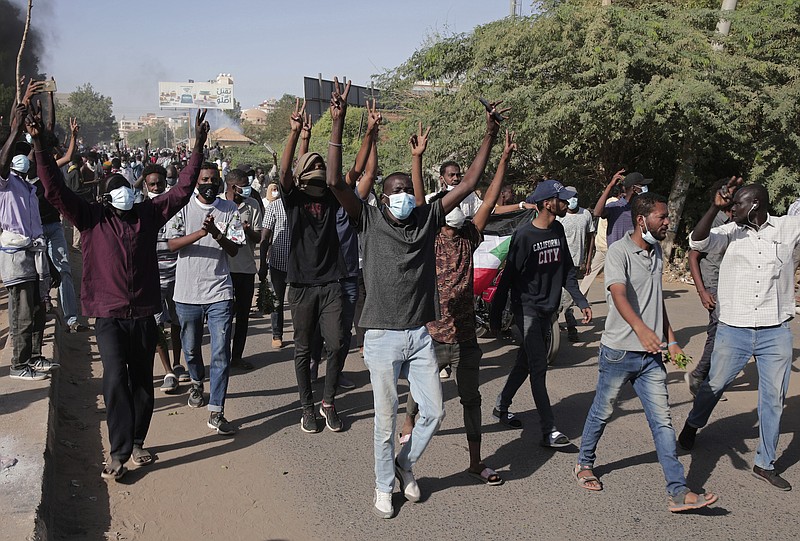 Sudanese protest against the military takeover, which upended the country’s fragile transition to democracy, in Khartoum, Sudan, Sunday, Nov. 21, 2021. Sudan’s military and civilian leaders signed a deal Sunday to reinstate Prime Minister Abdalla Hamdok, who was deposed in a coup last month. The country’s top general, Abdel Fattah Burhan, said in televised statements that Hamdok will lead an independent technocratic Cabinet until elections can be held. (AP Photo/Marwan Ali)