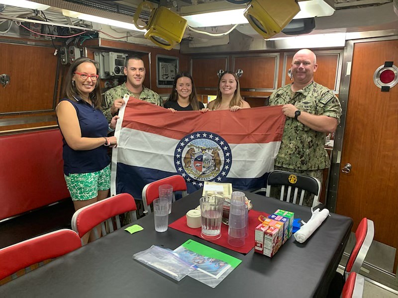 <p>Submitted</p><p>From left, Councilwoman Wiseman is shown with Lt. Cmdr. Eric Stinson, Claire Bonnot, Taylor Lalk and Chief of Boat Frank Cook. They are holding the Missouri flag that flew over the Capitol building on Missouri’s bicentennial day, which was gifted to the submarine.</p>