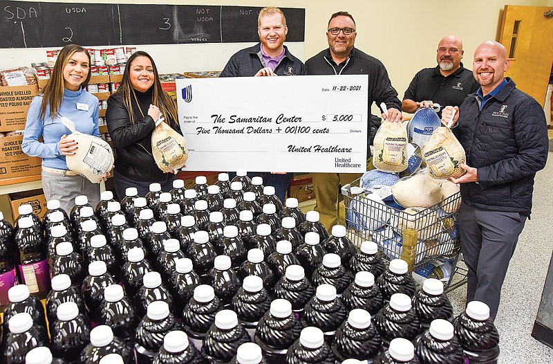 Invictus Marketing has teamed with United Healthcare to donate $5,000 to the Samaritan Center in Jefferson City to help with this year's high demand for food. Pictured from left to right are: Shelby Miller, UHC; Aura Velasquez, Cody Amos, Travis LePage, Chris Sneller and Scott Amos, all of Invictus Health and Wealth.