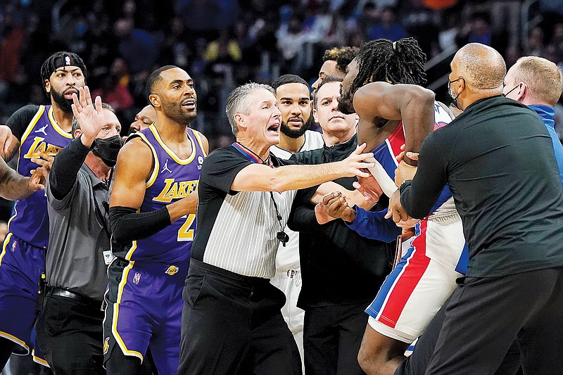 Players and an official separate Isaiah Stewart of the Pistons from LeBron James of the Lakers (not pictured) during Sunday's game in Detroit.