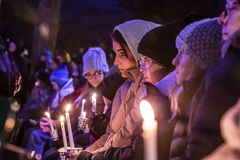 People gather in Waukesha's Cutler Park for a candlelight vigil  for those affected by the Waukesha Christmas Parade tragedy, Monday, Nov. 22, 2021 in Waukesha, Wis.. The event was hosted by the Association of Waukesha Congregations with participation by the Brookfield - Elm Grove Interfaith Network (BEGIN) and the Interfaith Conference of Greater Milwaukee.(Scott Ash/Milwaukee Journal-Sentinel via AP)