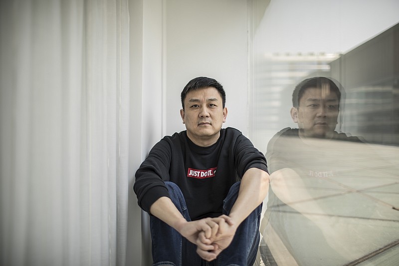 FILE - U.S. citizen Daniel Hsu poses for a portrait in the apartment in Shanghai, China, April 13, 2020.   Hsu, a U.S. citizen, fought for four years to escape China.  The Seattle resident was barred from leaving despite having committed no crime, a pawn in a geopolitical game between two giant superpowers.  Then earlier this month, just four days before the virtual meeting between President Joe Biden and Chinese leader Xi Jinping, Hsu was told to prepare to go home. He had less than 48 hours.  (AP Photo, File)