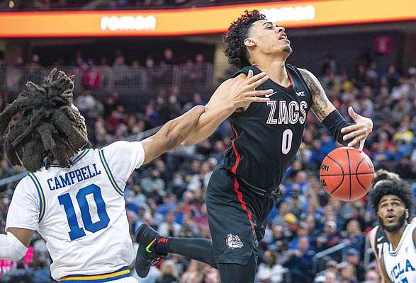 UCLA guard Tyger Campbell fouls Gonzaga guard Julian Strawther on a drive to the basket during the second half of Tuesday night's game in Las Vegas.