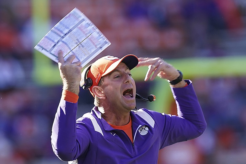 In this Nov. 13 file photo, Clemson head coach Dabo Swinney yells toward the players in the second half of a game against Connecticut in Clemson, S.C. For the first time since the College Football Playoff was introduced in 2014, the Atlantic Coast Conference will not be part of the four-team elimination format.