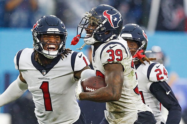 Texans cornerback Terrance Mitchell (39) celebrates with free safety Lonnie Johnson (1) after Mitchell intercepted a pass in the fourth quarter of last Sunday's 22-13 win against the Titans in Nashville, Tenn.