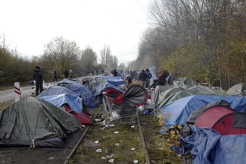 A migrants makeshift camp is set up in Calais, northern France, Saturday, Nov. 27, 2021. At the makeshift camps outside Calais, migrants are digging in, waiting for the chance to make a dash across the English Channel despite the news that at least 27 people died this week when their boat sank a few miles from the French coast. (AP Photo/Rafael Yaghobzadeh)