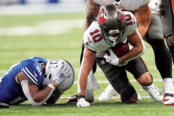 Scott Miller of the Buccaneers recovers a fumble by Nyheim Hines of the Colts (left) during the second half of Sunday's game in Indianapolis.