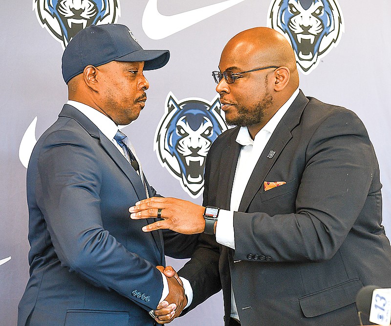 New Lincoln football coach Jermaine Gales (left) shakes hands with Lincoln athletic director Kevin Wilson on Monday, Nov. 29, 2022, during his introductory press conference at The LINC.