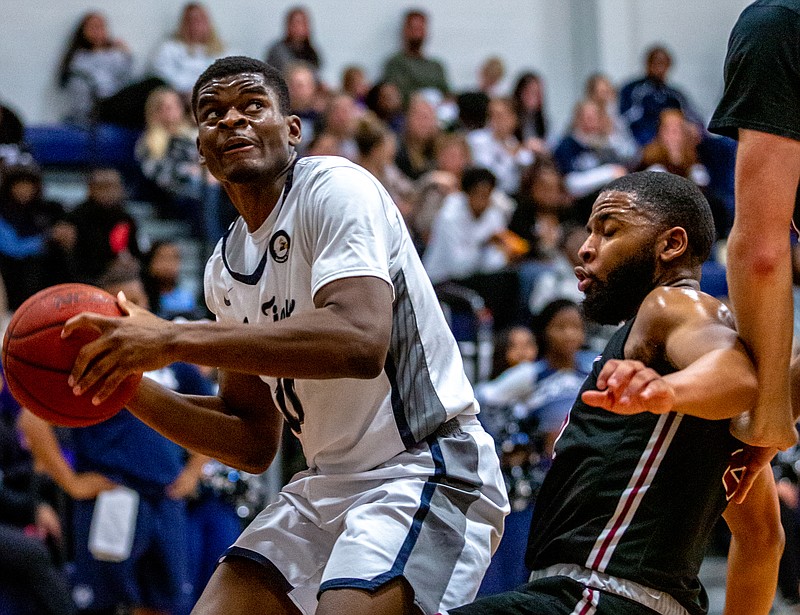 Alafia Oluwasogo of Lincoln looks for an opening to take a shot during Tuesday night's game against Central Christian College of the Bible at Jason Gym.