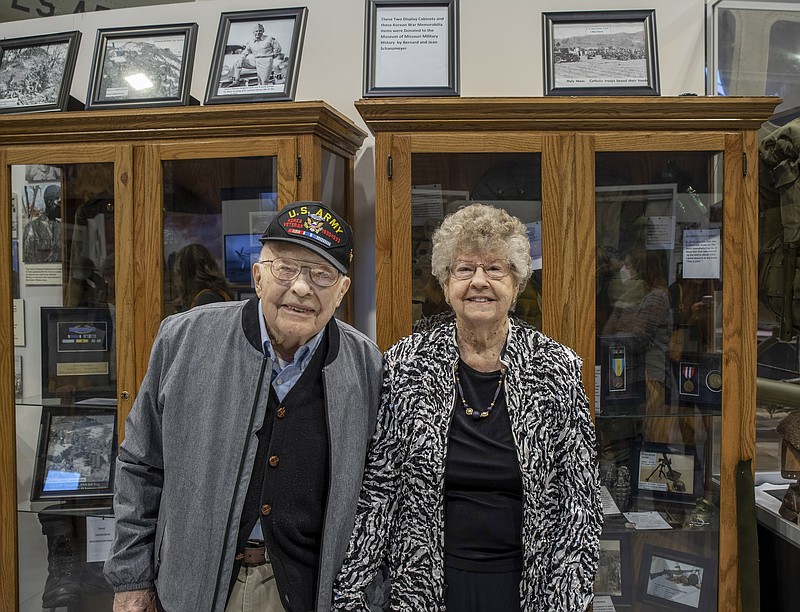 <p>Local U.S. Army veteran Bernard Schanzmeyer and his wife, Jean, are pictured with the display of their collection of Korean War artifacts and memorabilia, which they recently donated to the Museum of Missouri Military History.</p>
