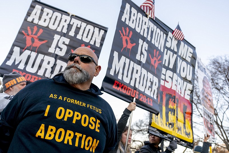 Anti-abortion protesters surround abortion rights advocates as both groups demonstrate in front of the U.S. Supreme Court, Wednesday, Dec. 1, 2021, in Washington, as the court hears arguments in a case from Mississippi, where a 2018 law would ban abortions after 15 weeks of pregnancy, well before viability. (AP Photo/Andrew Harnik)