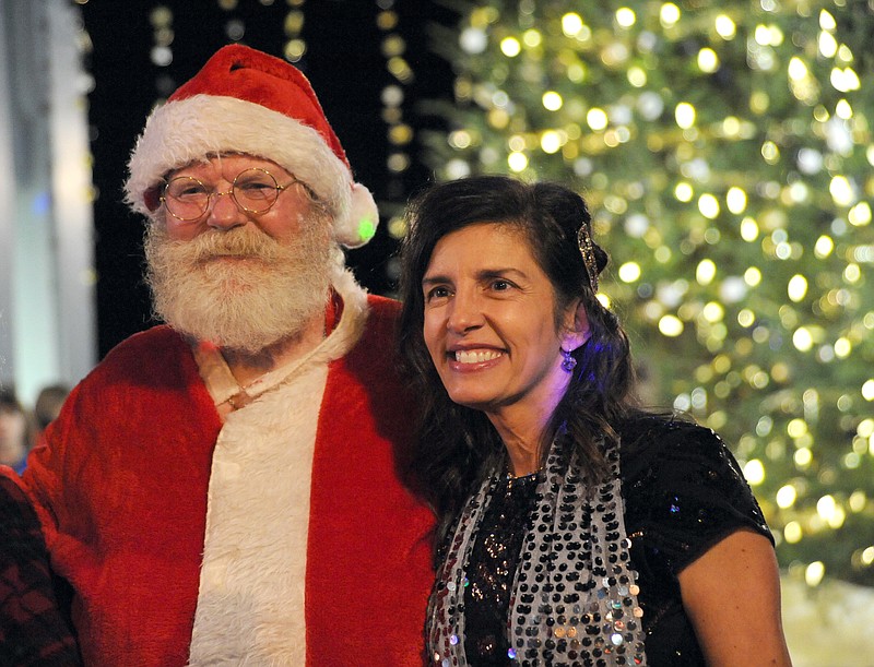 Jefferson City Mayor Carrie Tergin poses with Santa Claus after she lit the Christmas tree as part of the JC Parks 16th annual lighting of the tree at the Rotary Centennial Park on Bolivar Street.