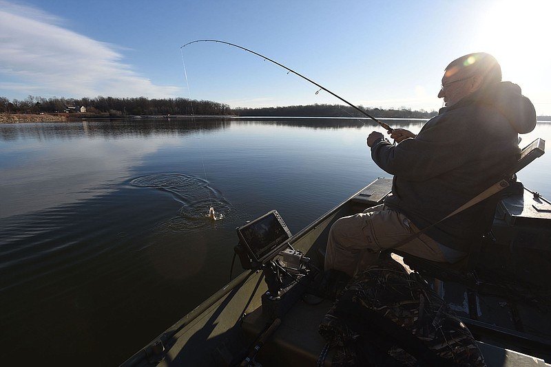 Mike McBride of Winslow cranks in a feisty crappie on Feb. 5 at Lake Elmdale. Small jigs worked to catch the tasty panfish at the Arkansas Game and Fish Commission lake near Elm Springs and Springdale.
(NWA Democrat-Gazette/Flip Putthoff)