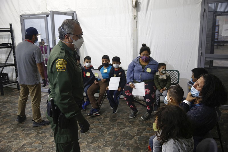 Migrants are processed at the intake area of the U.S. Customs and Border Protection facility, the main detention center for unaccompanied children in the Rio Grande Valley, in Donna, Texas, Tuesday, March 30, 2021. (AP Photo/Dario Lopez-Mills, Pool)