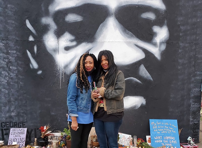 Paris Stevens, left, cousin of George Floyd, and Angela Harrelson, aunt of Floyd, visit the George Floyd Square Memorial Site, a sacred space where Floyd took his last breath, created by the Minneapolis community for public grief, protest and to connect with other caring individuals. (Special to the Commercial)