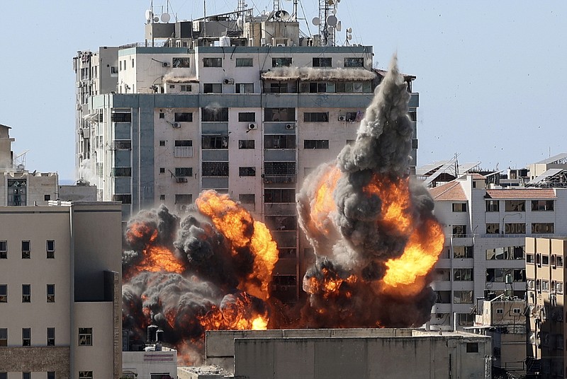 A ball of fire erupts from a building housing various international media, including The Associated Press, after an Israeli airstrike on Saturday, May 15, 2021 in Gaza City. The attack came roughly an hour after the Israeli military ordered people to evacuate the building, which also housed Al-Jazeera and a number of offices and apartments. There was no immediate explanation for why the building was targeted. (Mahmud Hams /Pool Photo via AP)