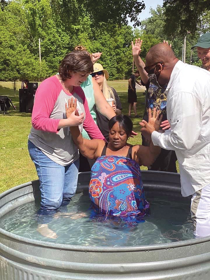 Latrisa Green, center, is baptised by Leah West of Bethel Little Rock, left, and Earl Matlock of Full Counsel Metro Church in North Little Rock during a Unity in the Community event on May 16 at Riverview Skate Park in North Little Rock. The next rally will take place July 18 at Lonoke City Park. The event will feature various speakers, testimonies and free food.