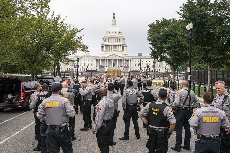 Police stage at a security fence ahead of a rally near the U.S. Capitol in Washington, Saturday, Sept. 18, 2021. The rally was planned by allies of former President Donald Trump and aimed at supporting the so-called "political prisoners" of the Jan. 6 insurrection at the U.S. Capitol. (AP Photo/Nathan Howard)