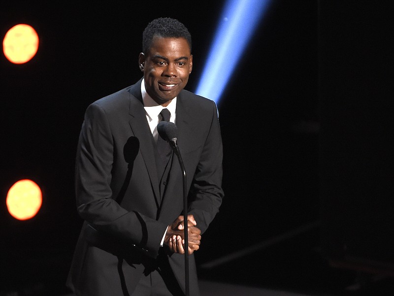 FILE - In this March 30, 2019 file photo, Chris Rock presents the award for outstanding comedy series at the 50th annual NAACP Image Awards at the Dolby Theatre in Los Angeles. Chris Rock on Sunday, Sept. 19, 2021 said he has been diagnosed with COVID-19 and sent a message to anyone still on the fence: “Get vaccinated.” (Photo by Chris Pizzello/Invision/AP, File)