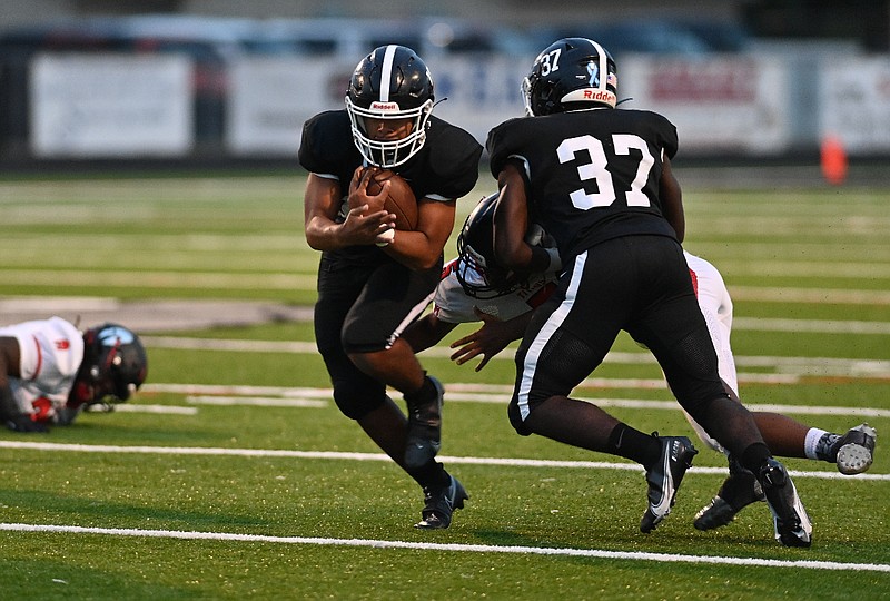 White Hall quarterback Mathew Martinez takes a block from Eric Pickens and finds running room against Jacksonville on Friday, Sept. 24, 2021, at Bulldog Stadium. (Special to The Commercial/Darlena Roberts)