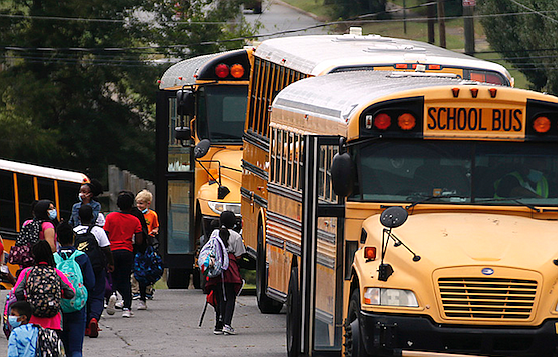 Students make their way to their buses as school lets out on Friday, Oct. 1, 2021, at Booker Arts Magnet Elementary School in Little Rock. (Arkansas Democrat-Gazette/Thomas Metthe)