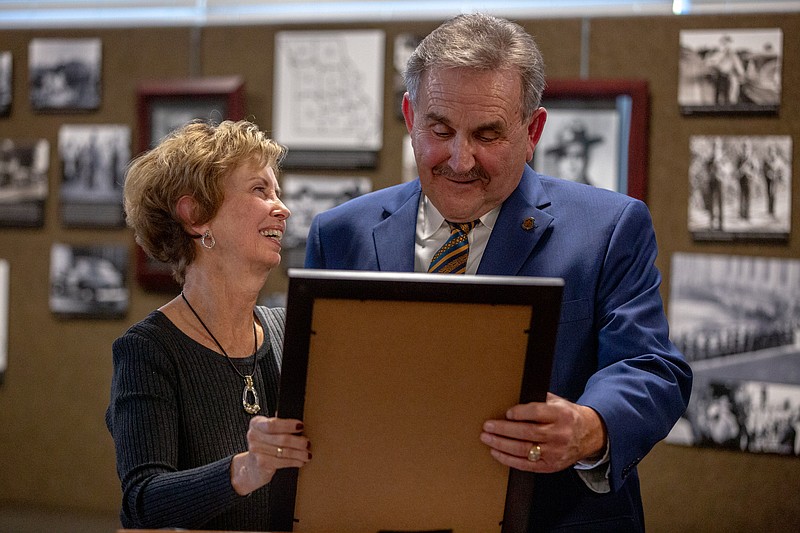 Former Sen. Doug Libla, right, reads a senate proclamation to his wife, Elaine Libla, commending her for her years of service to the Missouri Association of State Troopers Emergency Relief Society on Thursday, Dec. 9, 2021 at the High Way Patrol Headquarters in Jefferson City, Mo. A wall in the headquarters’ museum was dedicated to Libla. (Ethan Weston/News Tribune)