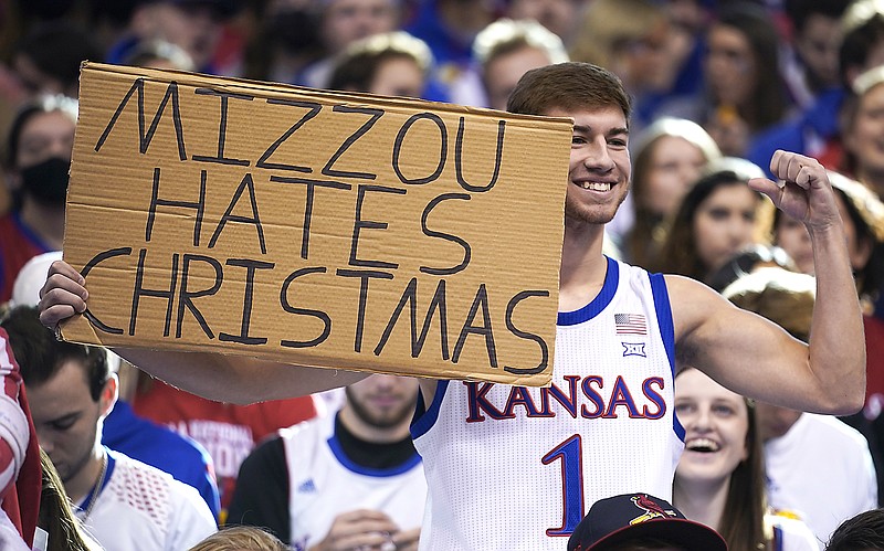 A fan holds up a sign during the first half of Saturday's game between Missouri and Kansas in Lawrence, Kan. (Associated Press)