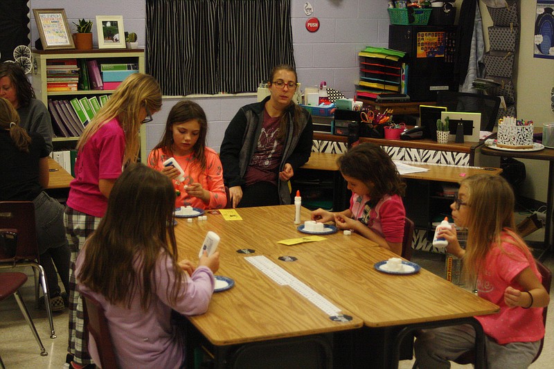 Children glue together sugar cubes for their igloos they were building Wednesday as part of New Bloomfield's PIE night at the elementary school. This was the second Partners in Education event and this one had a "Polar Express" theme that featured several activities that dealt with winter.