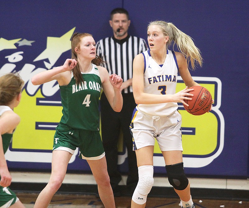 Autumn Bax of Blair Oaks applies defensive pressure against Fatima’s Morgan Luebbering during the first half of Tuesday night’s game in Westphalia. (Greg Jackson/News Tribune)