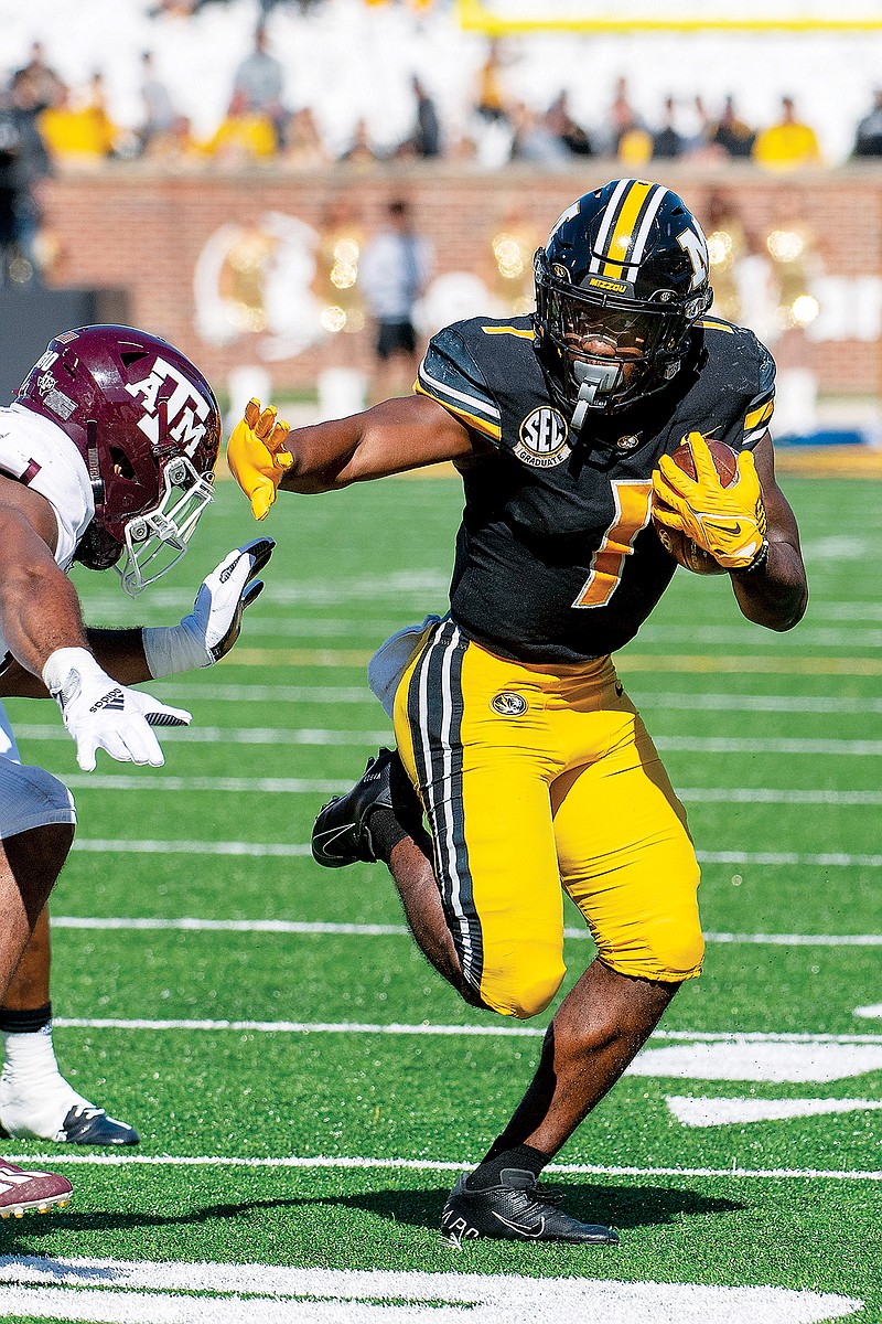 In this Oct. 16 file photo, Missouri running back Tyler Badie pushes past a Texas A&M defender during a game at Faurot Field. (Associated Press)