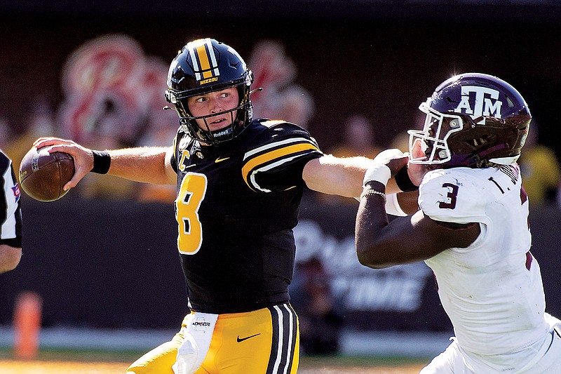 In this Oct. 16 file photo, Missouri quarterback Connor Bazelak fights off Texas A&M’s Tyree Johnson as he looks to pass during a game at Faurot Field. (Associated Press)